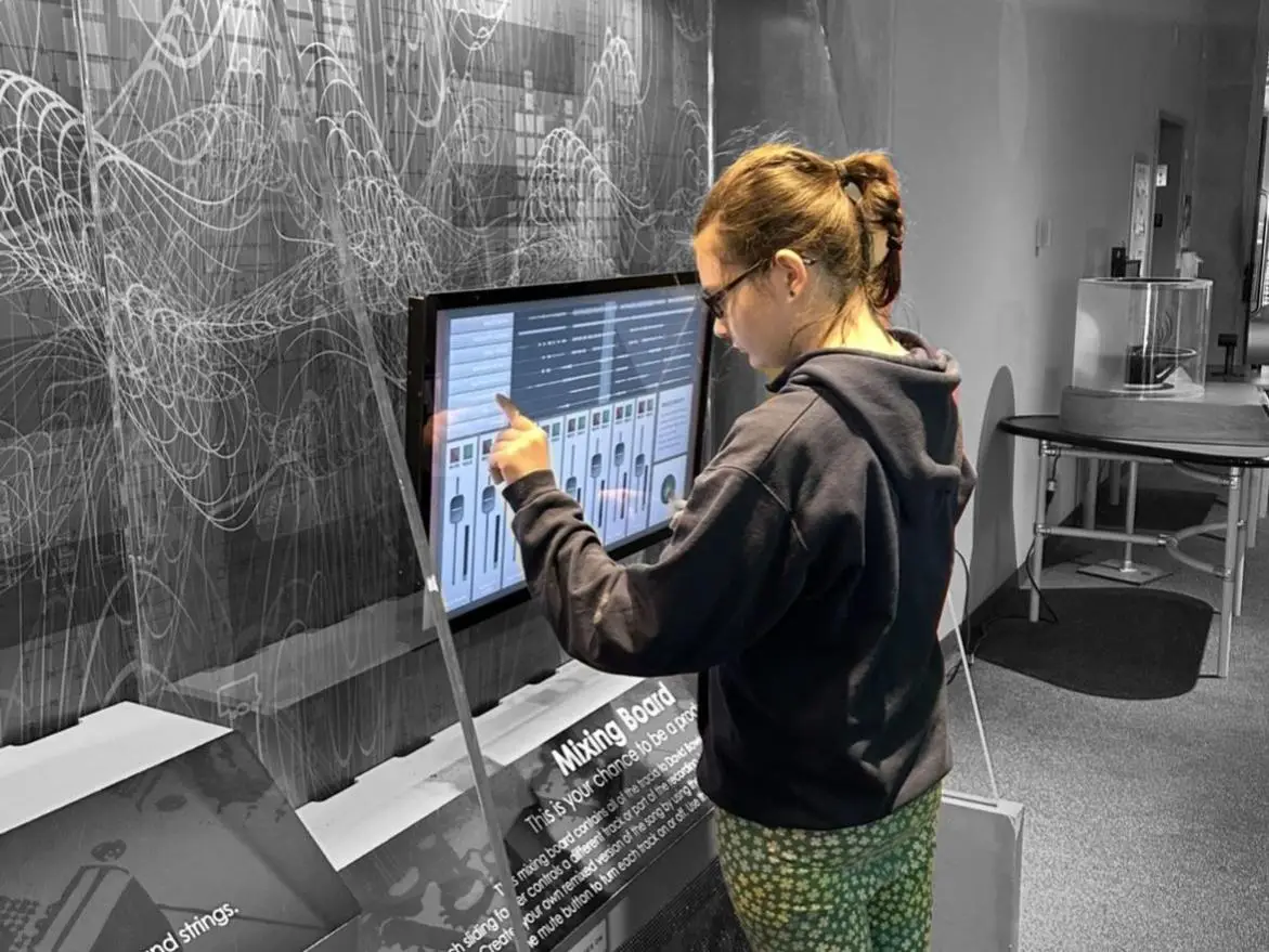 Girl standing at large touchscreen